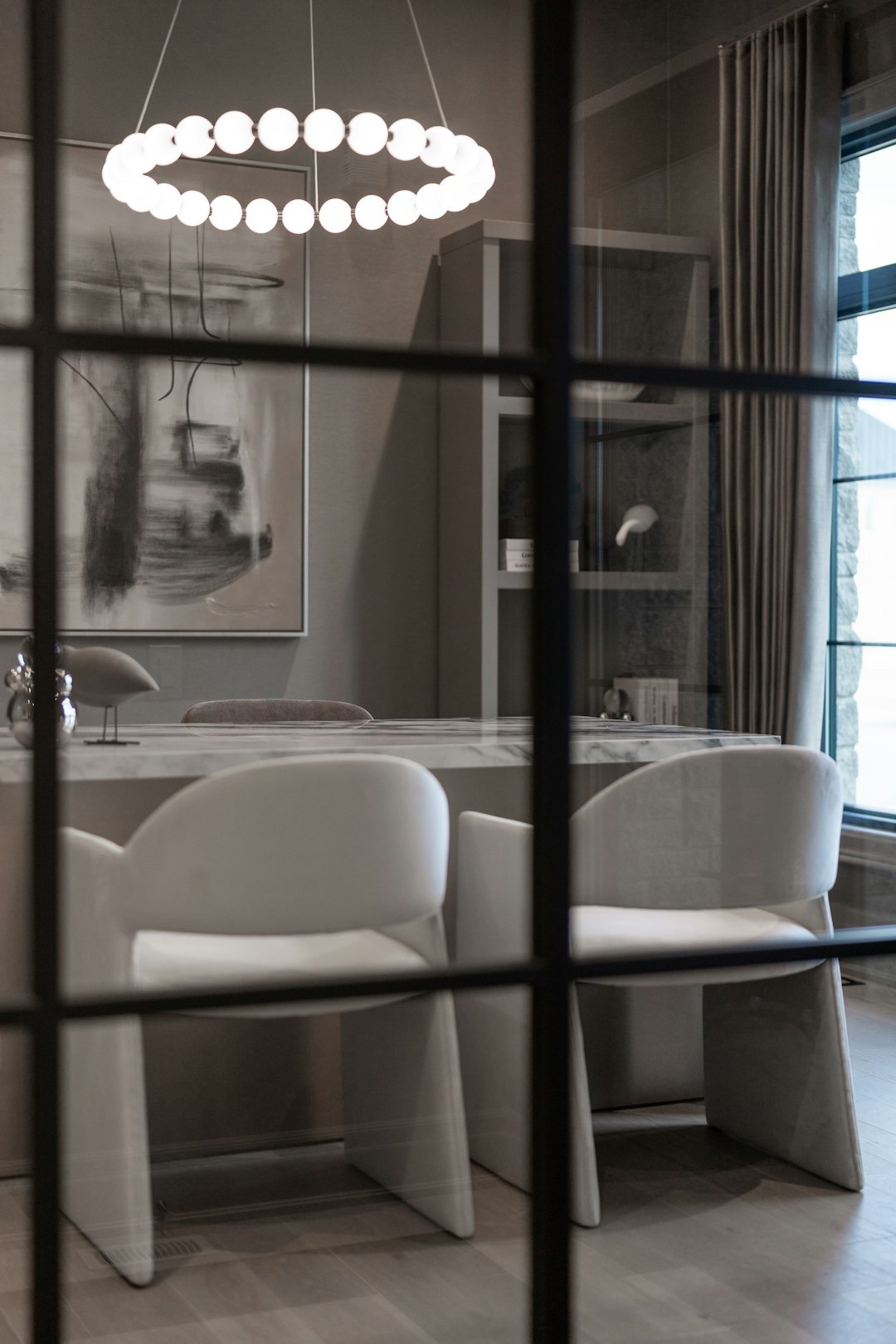 Modern office interior with marble table and contemporary chairs.